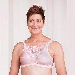 Trulife Jessica Mastectomy Bra Powder Pink. Photo of a woman modeling the bra.